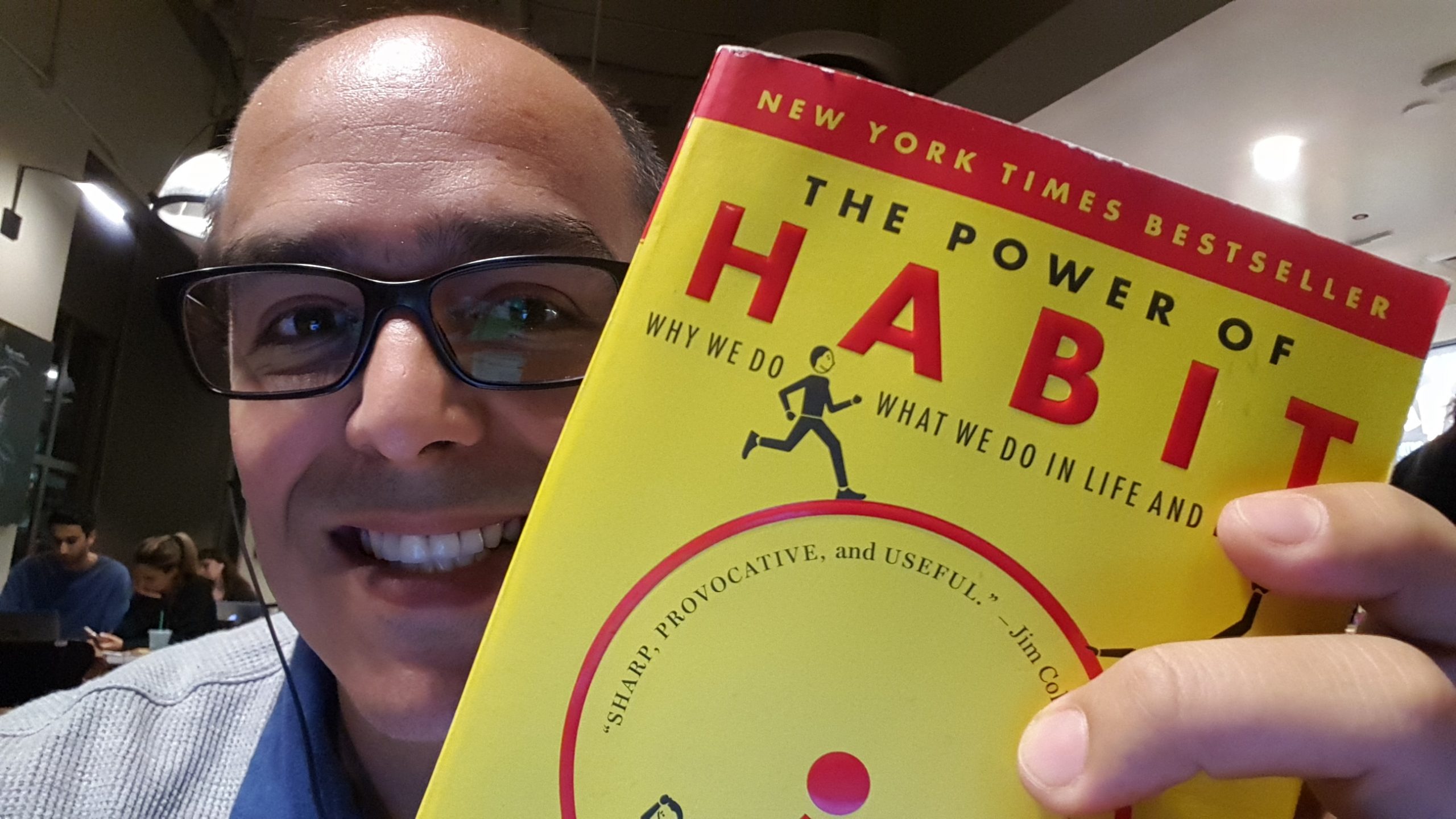 Picture of Oscar Gonzalez holding The Power of Habit book