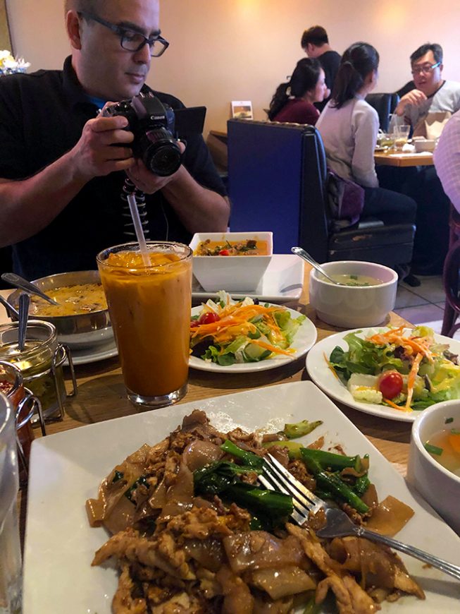 Photo of the pad see ew noodles and other items set at the table